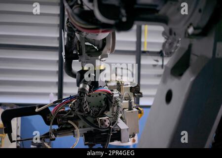 Engineer work at robotic arm factory. Technology and engineering concept. Stock Photo