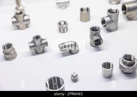 Metal Pipe Fittings or Pipe Connectors Piping and plumbing on white background Stock Photo