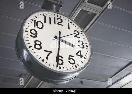 Classic Train Station Clock. Working hours Office Time in urban city landscape in people lifestyle. Stock Photo