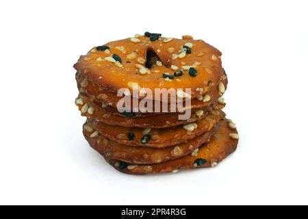 Round salty pretzels wtih black and white sesame isolated on white background high quality details Stock Photo