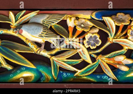 Detail of the extensive wooden carvings of flowers and birds on the sukibei wall at the Ueno Tosho-gu Shrine in Ueno Park, Tokyo, Japan. The shrine was constructed in 1627 and is considered a great example of Shinto architecture from the Edo period. Stock Photo