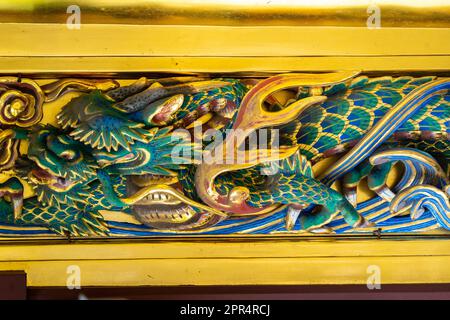 Detail of the extensive wooden carvings of flowers and birds on the sukibei wall at the Ueno Tosho-gu Shrine in Ueno Park, Tokyo, Japan. The shrine was constructed in 1627 and is considered a great example of Shinto architecture from the Edo period. Stock Photo