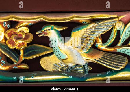 Detail of the extensive wooden carvings of flowers and birds on the sukibei wall at the Ueno Tosho-gu Shrine in Ueno Park, Tokyo, Japan. The shrine was constructed in 1627 and is considered a great example of Shinto architecture from the Edo period. Stock Photo