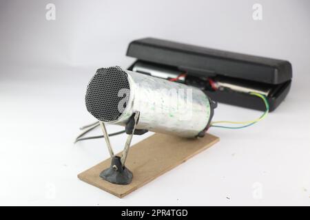 Air heating device made using recycled materials and heating element powered by the battery on a white background. Homemade inventions Stock Photo