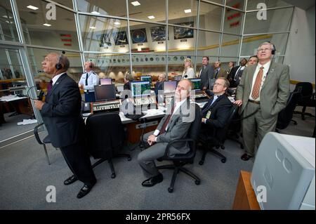 NASA Administrator Charles Bolden, left, and other NASA managers monitor the launch of space shuttle Endeavour (STS-134) in Firing Room 4, Monday, May 16, 2011, at Kennedy Space Center in Cape Canaveral, Fla. During the 16-day mission, Endeavour, with Commander Mark Kelly, Pilot Gregory H. Johnson, Mission Specialists Michael Fincke, Greg Chamitoff, Andrew Feustel and European Space Agency astronaut Robert Vittori will deliver the Alpha Magnetic Spectrometer (AMS) and spare parts including two S-band communications antennas, a high-pressure gas tank and additional spare parts for Dextre. Photo Stock Photo