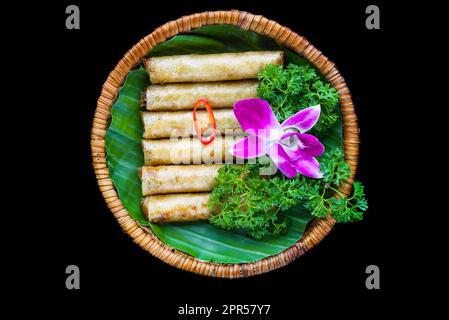 Traditional fried vietnamese spring rolls with pork, rice paper on black background side view Stock Photo