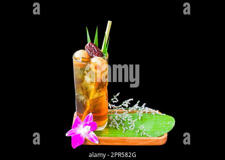 Vietnamese tamarind juice with goji berries isolated on black background Stock Photo