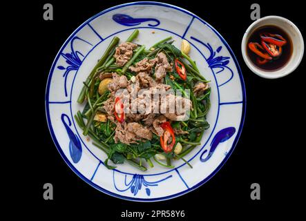 Vietnamese stir fried beef with morning glory Stock Photo