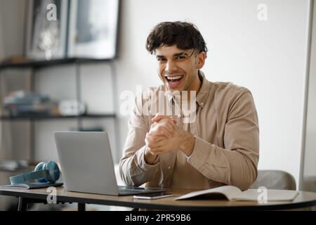 Joyful Businessman At Laptop Rubbing Hands Anticipating Success In Office Stock Photo