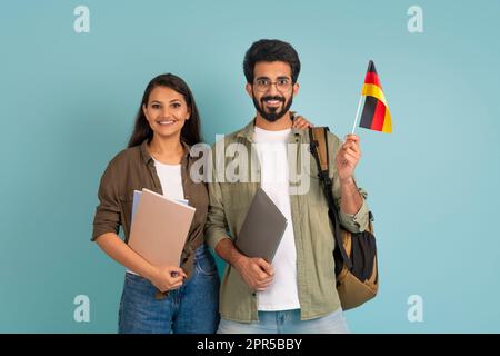 Happy young indian couple students with flag of Germany Stock Photo
