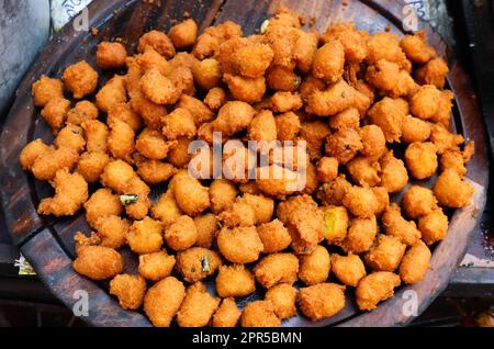 Tasty Pakora aka Pakoda. Indian Deep Fried Street Food on Sale. Stock Photo