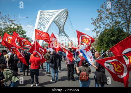 Protesters wave the red flags of the Italian Communist Party before crossing the Settimia Spizzichino bridge during the demonstration. About 10 thousand demonstrators took part during the parade organized by the ANPI (National Association of Partisans of Italy) in Rome on the occasion of the 78th anniversary of the Liberation from Nazi-fascism. Starting from Largo Bompiani, they crossed the neighborhoods of Tor Marancia, Garbatella and Ostiense, until they arrived at Porta San Paolo. The demonstration ended in Piazzale Ostiense with speeches by political figures, trade unions and the testimoni Stock Photo