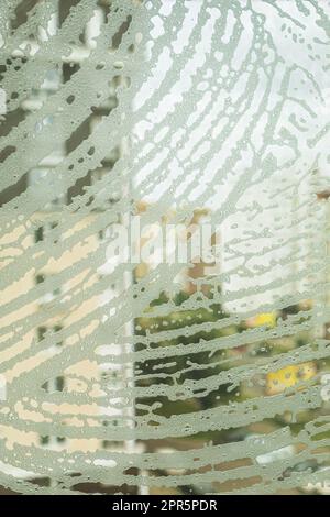 Soap foam on the window. Blurred view of abstract texture of soap solution foam on glass Stock Photo