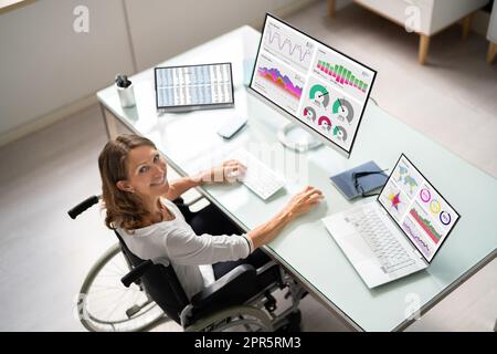 Happy Businesswoman At Workplace Using Keyboard Stock Photo