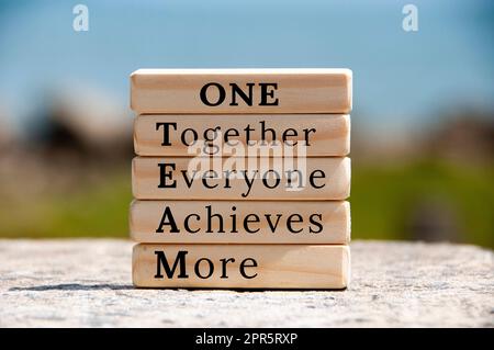 One Team text on wooden blocks with blurred nature background. Business and team work concept Stock Photo