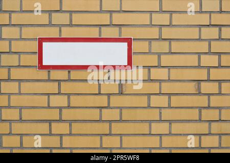 blank white sign with text free space on brick wall Stock Photo