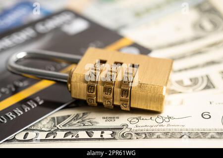 Credit card with password key lock security on US dollar background. Stock Photo