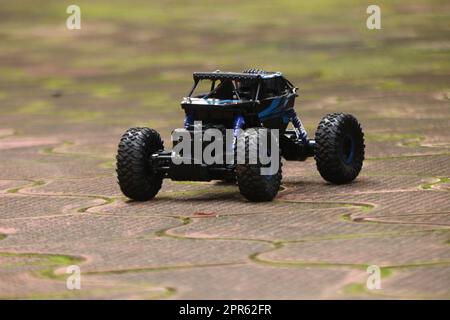 A black RC car driving on the floor Stock Photo