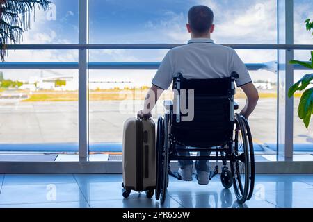 Young man in a wheelchair at the airport Stock Photo