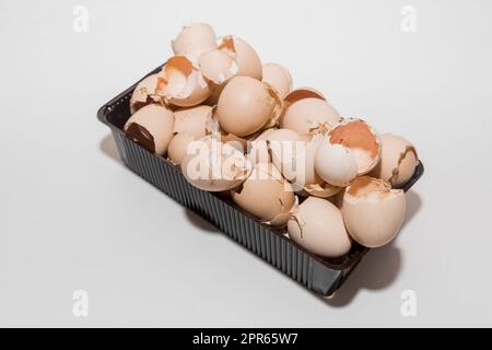 A lot of eggshells, chicken shells after the birth of chicks, a new life for nature, poultry farming on a white background. Stock Photo