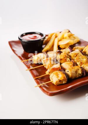 Chicken skewers. Pieces of tender chicken fillet, grilled with sweet onion rings Stock Photo