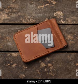 Leather red wallet with credit card on old wooden background Stock Photo