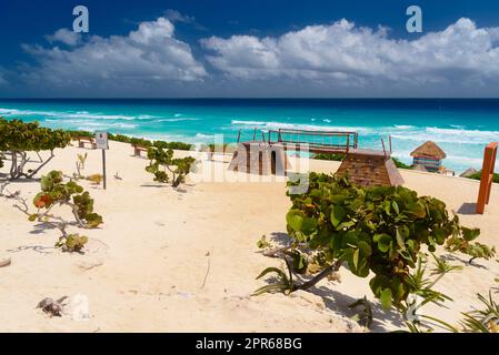 Sandy beach with azure water on a sunny day near Cancun, Mexico Stock Photo