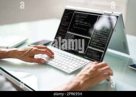 Programmer Or Coder At Office Desk Stock Photo