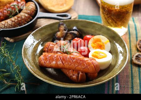 Beer and snacks (sausages with grilled vegetables and boiled eggs) Stock Photo