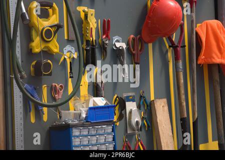 workshop tools hanging on the wall in a shed gardening equipment Stock Photo