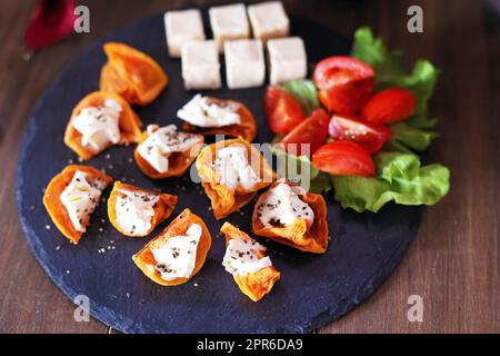 Hors d'oeuvre of dried persimmon and cream cheese for wine Stock Photo