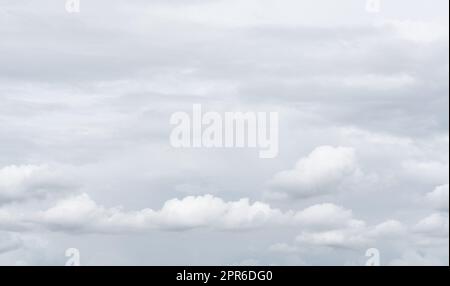 White cumulus clouds on gray sky texture background. Full frame of cloudscape background. Cloudy sky. Beauty in nature. White fluffy clouds. Nature weather. Soft texture like cotton of white clouds. Stock Photo
