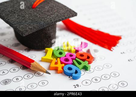 Math number with graduation gap hat on answer sheet test choice for learning Mathematic, education math concept. Stock Photo