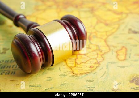 Bangkok, Thailand - December 15, 2021 Judges gavel on ancient vintage world map, international law concept. Stock Photo