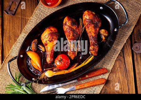 grilled chicken legs in barbecue marinade with sweet potatoes Stock Photo