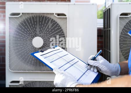 An Electrician Men Checking Air Conditioning Unit Stock Photo