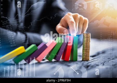 Close-up Of A Businessman's Hand Stopping Falling Blocks Stock Photo