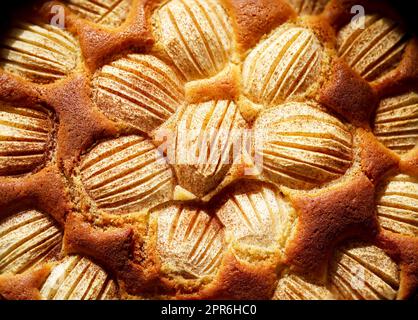 A ready-baked apple pie with cinnamon sprinkled over the apples. Stock Photo