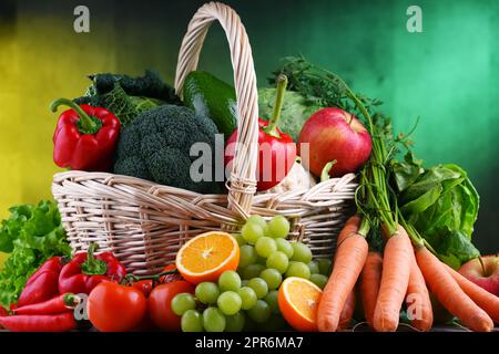 Fresh organic fruits and vegetables in wicker basket Stock Photo