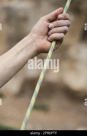 Hand holding a rock climbing rope Stock Photo