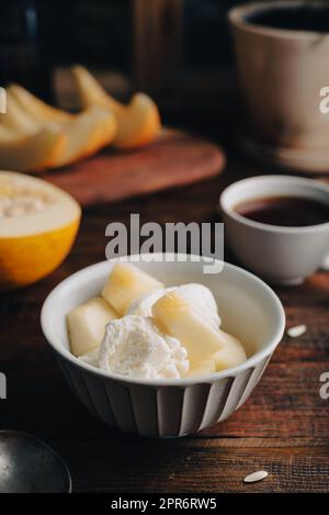 Ice Cream with Slices of Honeydew Melon Stock Photo