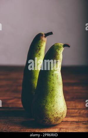 Two Green Pears on Wooden Table Stock Photo
