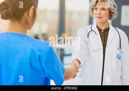 Partnering up for the protection and preservation of your health. Shot of a doctor and nurse shaking hands. Stock Photo