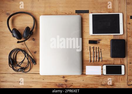 Ready to build a new device. High angle shot of wireless technology on a wooden table. Stock Photo