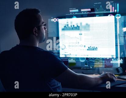 Programming new software. Cropped shot of a young computer programmer looking through data. Stock Photo