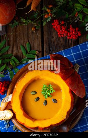 Delicious autumn pumpkin soup with baguette Stock Photo