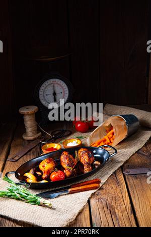 grilled chicken legs in barbecue marinade with sweet potatoes Stock Photo