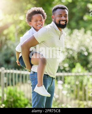 I just want to give him the best. Portrait of a father giving his son a piggyback ride outdoors. Stock Photo