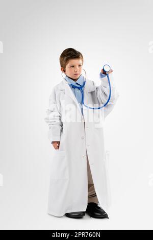 I want to help people when Im big. Studio shot of an adorable little boy dressing up as a doctor. Stock Photo