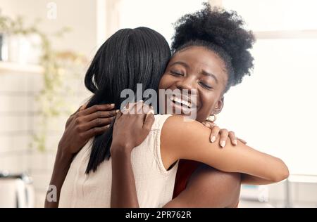 Finally reunited. Shot of two young friends spending time together at home. Stock Photo